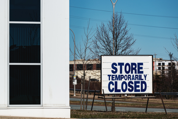 Closed business with a 'Temporarily Closed' sign, highlighting overlooked business insurance mistakes in Malaysia, like ignoring interruption coverage.