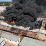 Building on fire, illustrating the importance of avoiding business insurance mistakes in Malaysia.